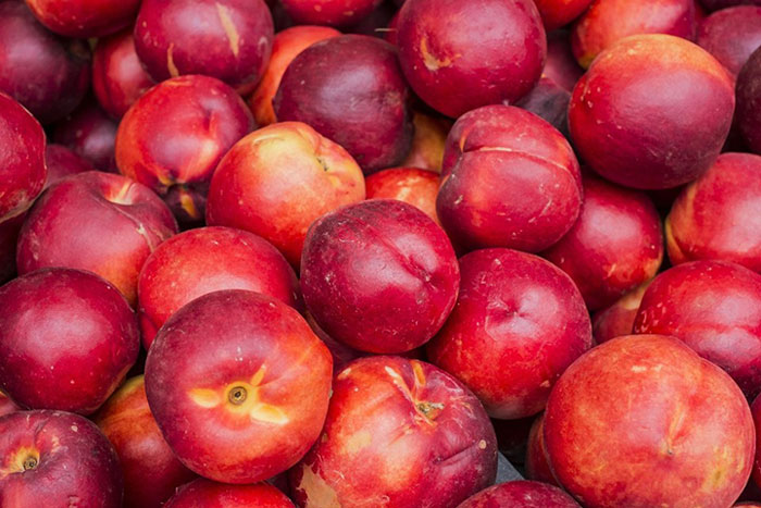 pile of red-orange orb shaped fruit